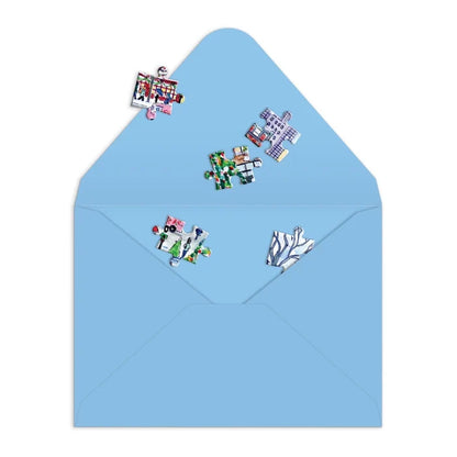 Blue envelope with colorful puzzle piece stickers on a white background