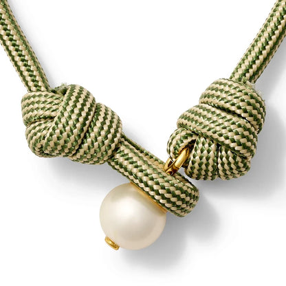 Olive green and beige bracelet with a pearl button closure on a white background
